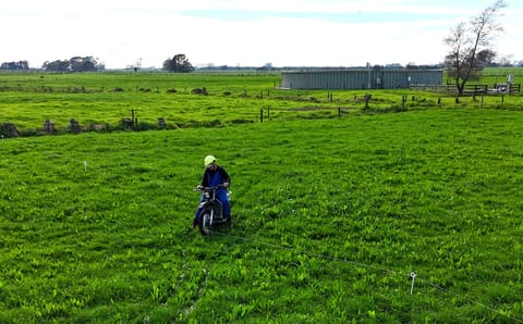 Galvbike crossing a paddock fence line