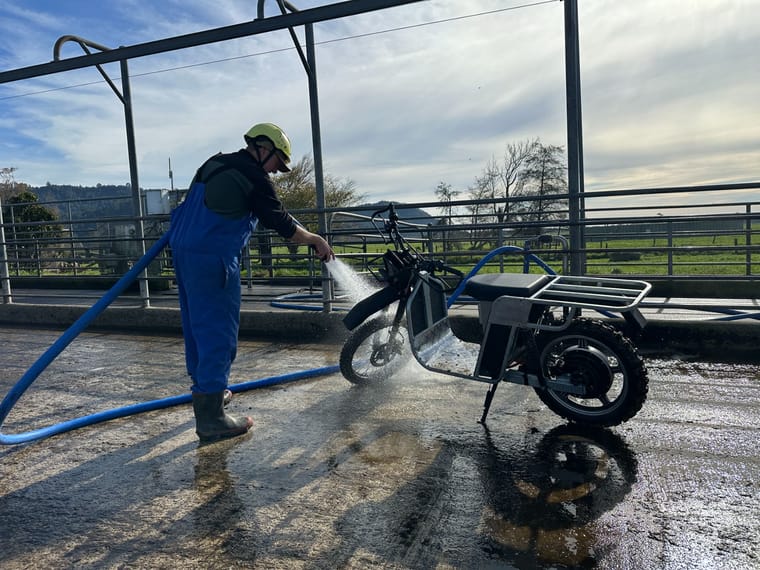 Galvbike being pressure-washed down on a dairy yard